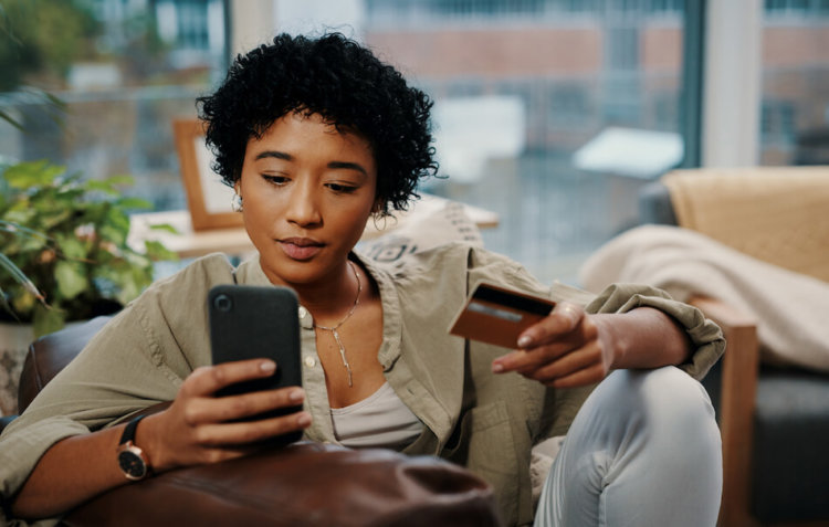 woman paying on phone with credit card